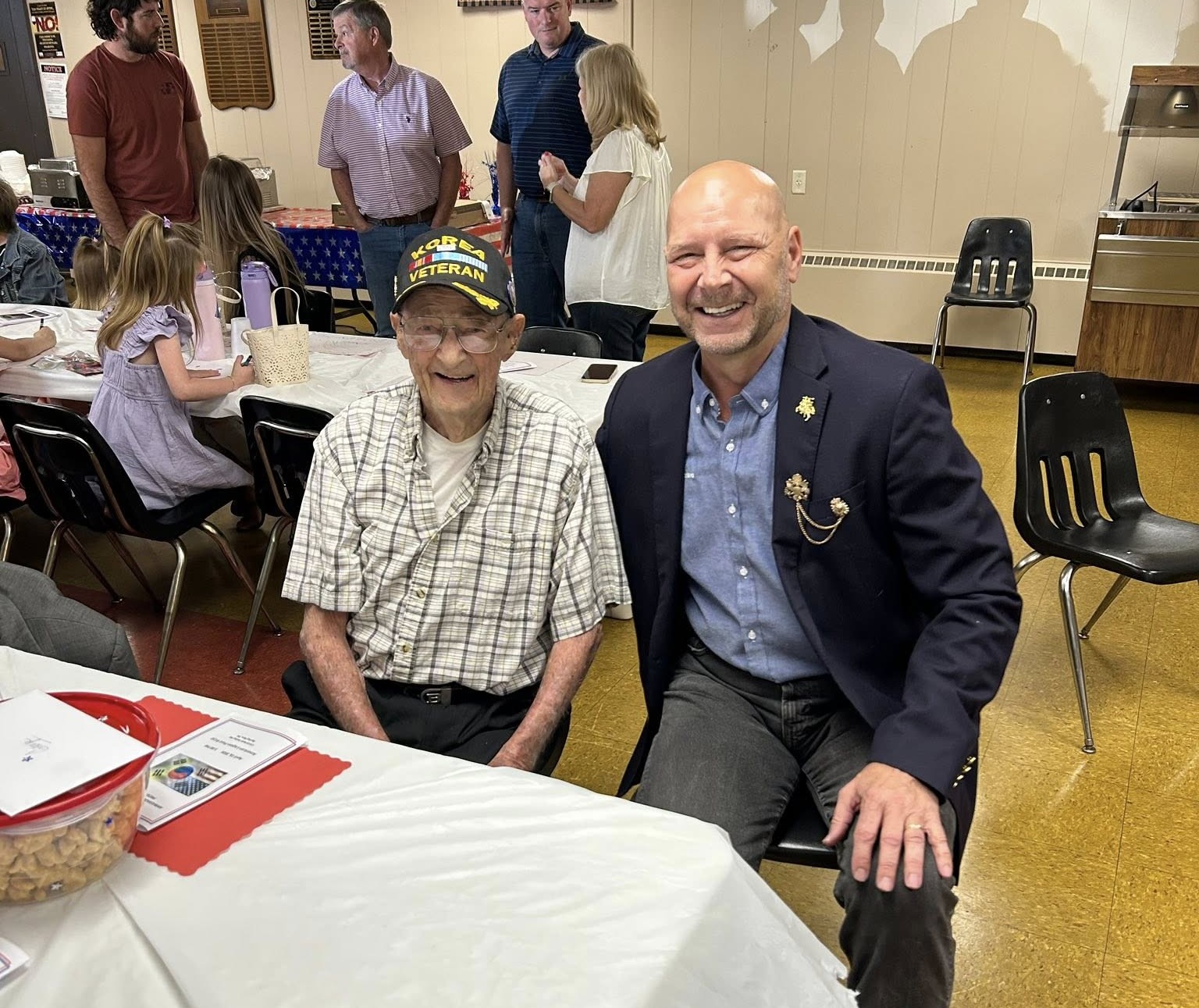 Sergeant First Class George Bucher Baker Jr. and Senator Doug Mastriano sit together at a Korean War Veteran’s Ceremony.