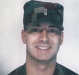 A headshot of a young Senator Mastriano as a Second Lt. He is wearing an army hat and army shirt