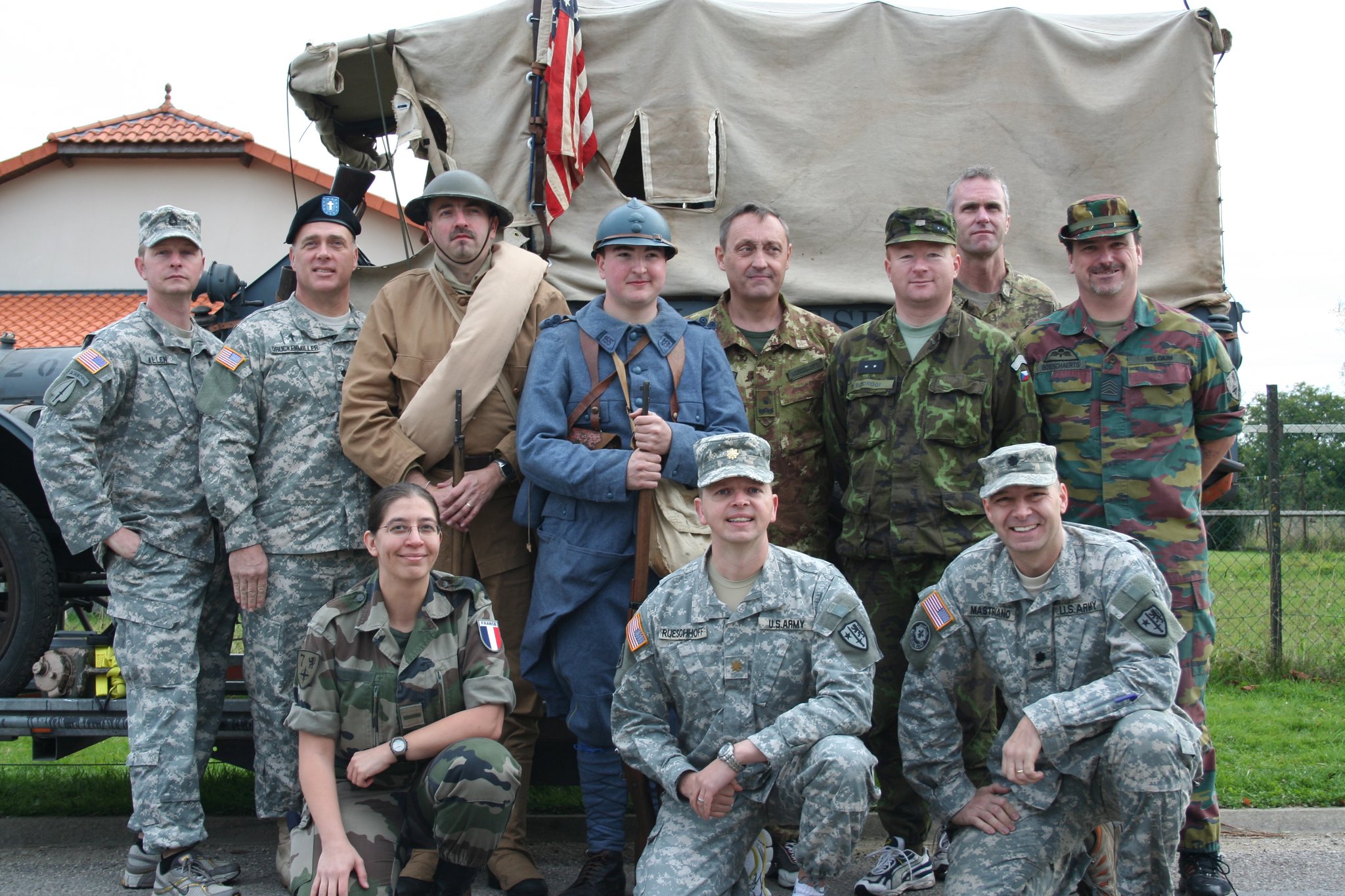 Senator Mastriano sitting on the bottom right side in his army outfit with other officers standing and sitting with him.