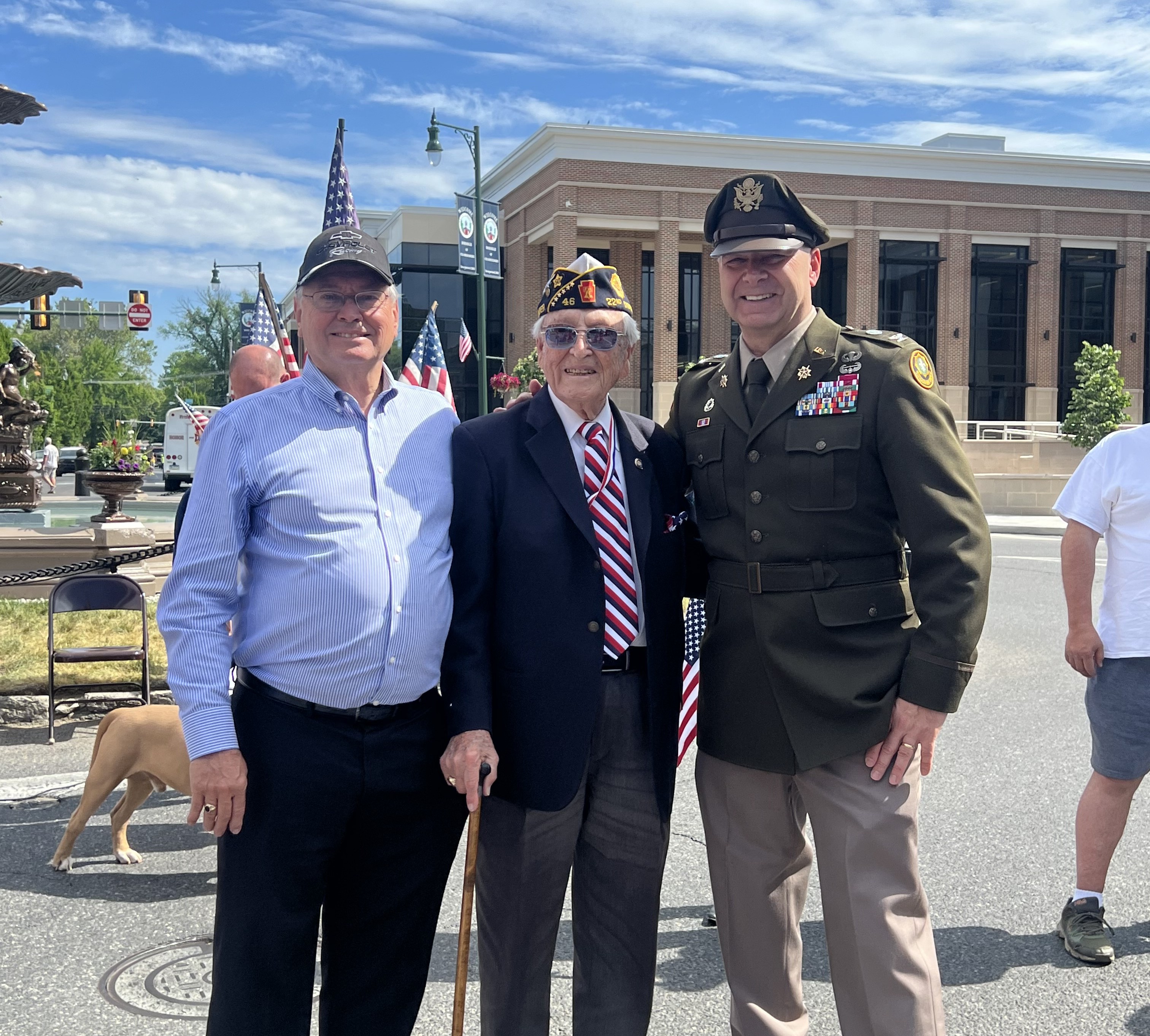 3 men standing together in front of a fountain in downtown Chambersburg
